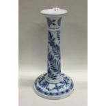 A Meissen blue tapering candlestick decorated with