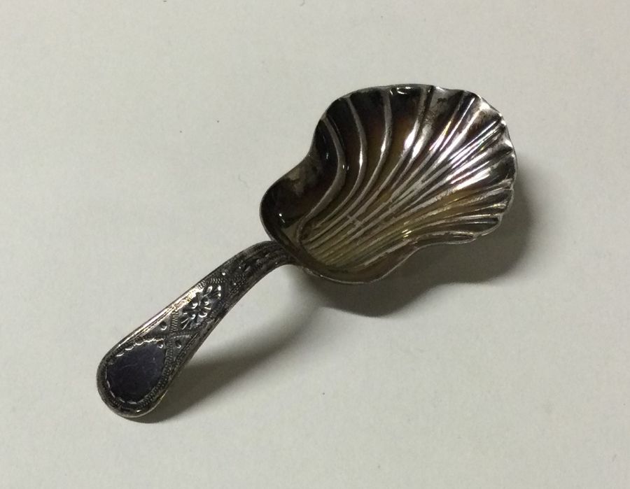 A George III chased silver caddy spoon. Chester. B