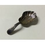 A George III chased silver caddy spoon. Chester. B