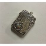 A large embossed silver vesta case with floral dec