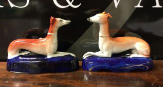 A matched pair of Staffordshire dogs in seated pos