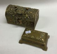 A cast brass dome top trunk together with a stamp