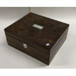 A rosewood and MOP hinged top jewellery box. Est.