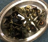 A tray containing brass and other door furniture.