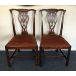 A pair of Georgian mahogany hall chairs with slip-