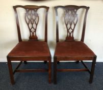 A pair of Georgian mahogany hall chairs with slip-