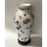 An attractive vase decorated with butterflies by T