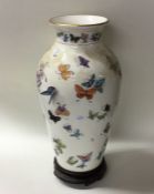 An attractive vase decorated with butterflies by T