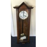 A good Edwardian wall clock with white enamelled d