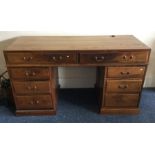 A mahogany twin pedestal desk with brass handles.