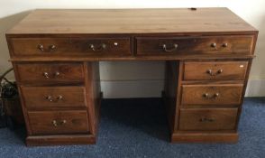 A mahogany twin pedestal desk with brass handles.