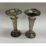 A pair of shaped silver spill vases of tapering fo