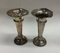 A pair of shaped silver spill vases of tapering fo