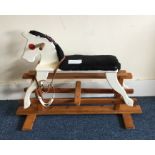 A painted child's rocking horse. Est. £25 - £30.