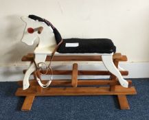 A painted child's rocking horse. Est. £25 - £30.