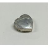 A silver heart shaped pill box with hinged lid. Ap