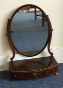 A Victorian bow front three drawer toilet mirror.