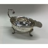 A George III silver sauce boat with card cut rim.