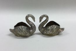 A pair of Continental silver cast swans with textu