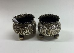 A pair of small chased silver salts with crimped r