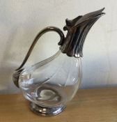 A silver plated decanter of stylised form. Est. £2