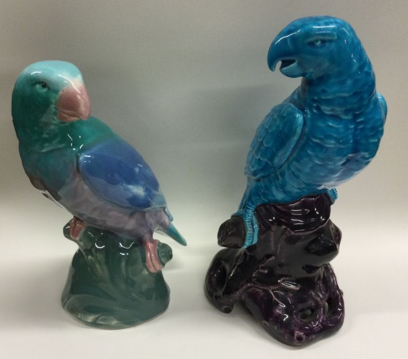 Two large pottery figures of parrots decorated in