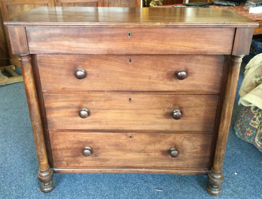 A mahogany chest of four drawers on bun feet. Est.