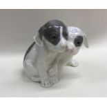 A Royal Copenhagen figure of tow puppies in seated