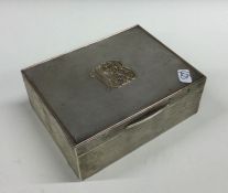 A heavy engine turned silver cigar box, the solid