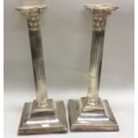 A tall pair of Edwardian silver candlesticks with