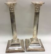 A tall pair of Edwardian silver candlesticks with