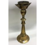 An unusual large brass candlestick of tapering for