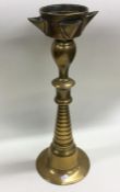 An unusual large brass candlestick of tapering for