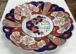 A large Imari charger decorated in typical form. A