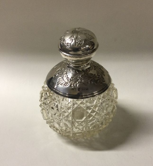 A heavy hobnail cut silver mounted scent bottle. B