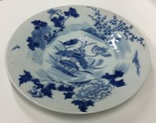 A Chinese blue and white plate decorated with flow