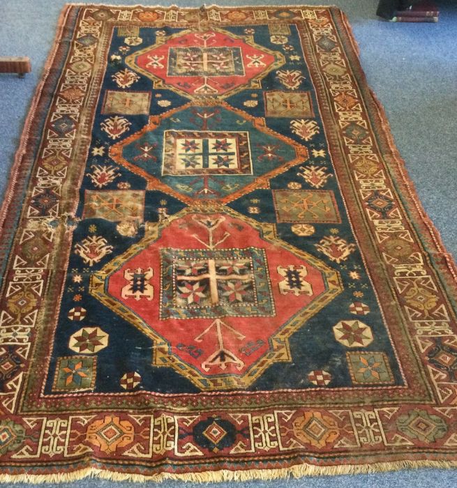An old rug decorated in bright colours. Est. £30 - - Image 2 of 3