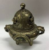 A Chinese brass censer decorated in relief with li