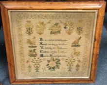 A maple framed sampler of typical form dated 1866.