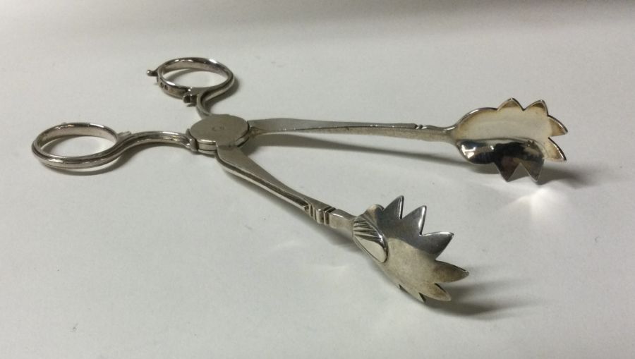 A pair of large Victorian silver ice tongs. London