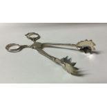 A pair of large Victorian silver ice tongs. London