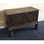 AN oak carved bible box on four turned supports. E