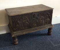 AN oak carved bible box on four turned supports. E