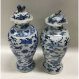 Two Chinese baluster shaped vases with covers. Sig