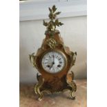 A French lacquered mantle clock decorated with fig