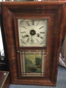 An old mahogany cased wall clock. Est. £30 - £50.