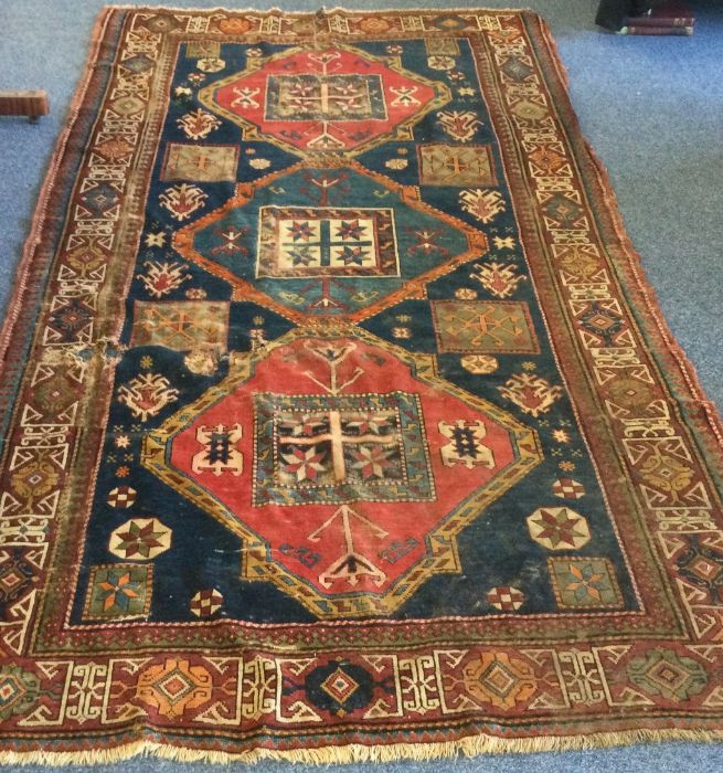 An old rug decorated in bright colours. Est. £30 - - Image 3 of 3