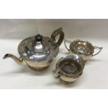 A heavy silver three piece pedestal tea service. L