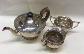 A heavy silver three piece pedestal tea service. L