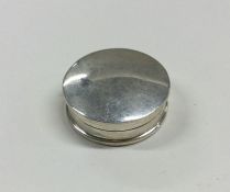 A circular silver pill box with hinged lid. Approx